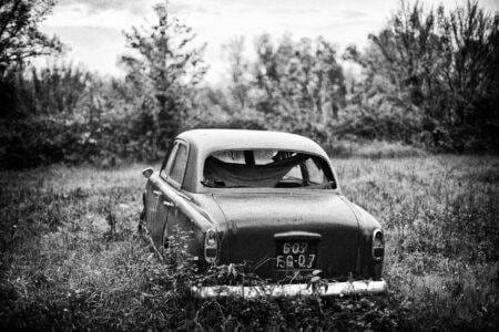 A Black And White Photo Of An Old Car Colorized With Ai Technology.